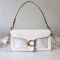Coah bag in white with textured panel, gold ring clasp, burgundy trim