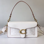 Coah bag in white with textured panel, gold ring clasp, burgundy trim