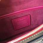 Burgundy interior fabric with leather brand tag and visible red zipper trim