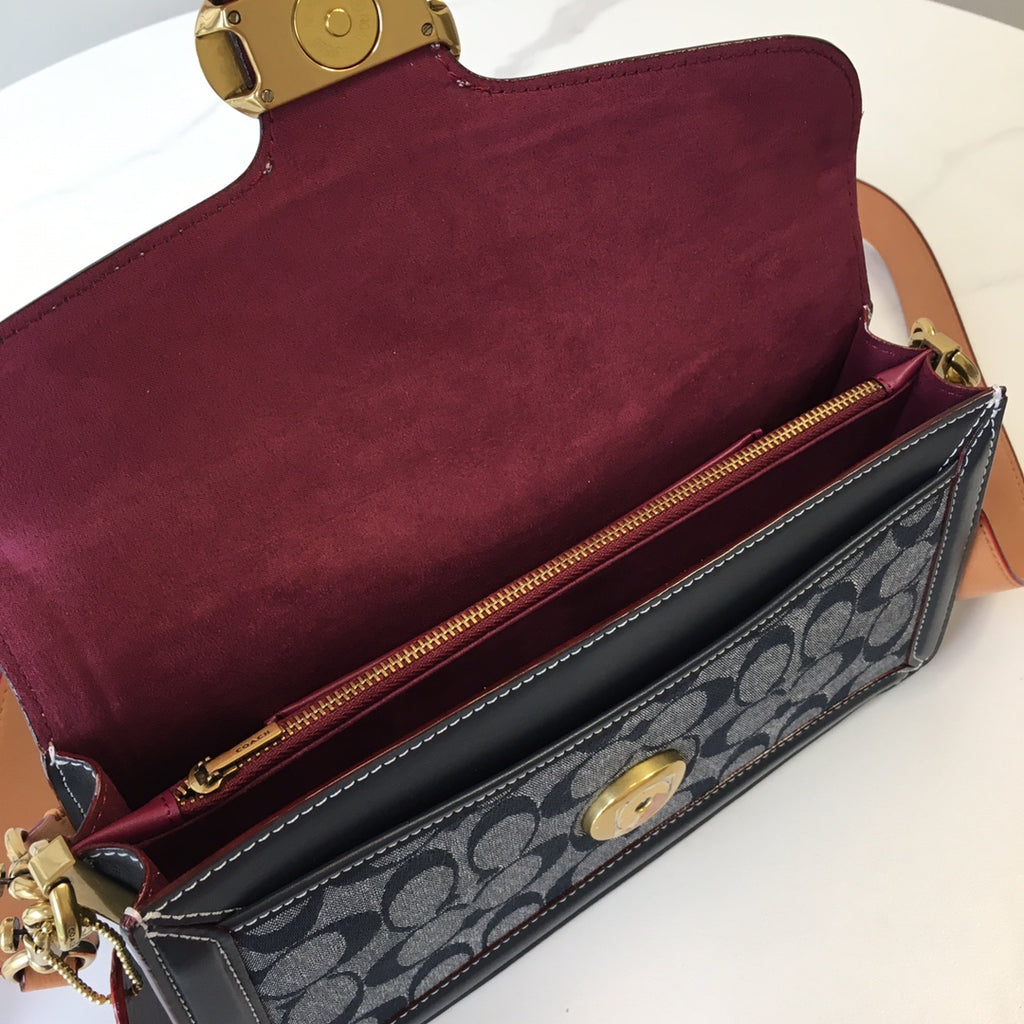 Handbag with burgundy interior and navy monogram front, gold turn-lock and zipper