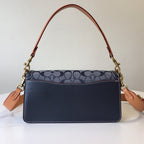 Navy monogram shoulder bag with tan strap and gold hardware, flat front flap