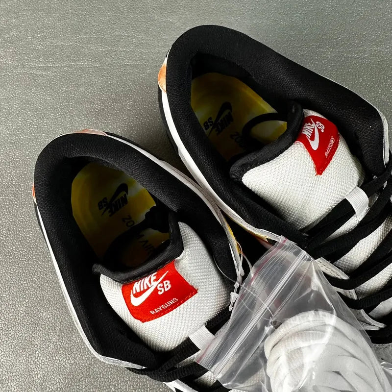 Nike Dunk SB Low Pro QS sneakers with black lining and white uppers, lace-up style