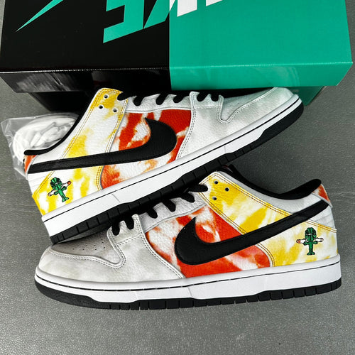 Pair of white low-top sneakers with yellow and orange graphic panels, black swoosh