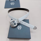 White leather belt with ornate silver buckle and floral keeper detail, laid flat