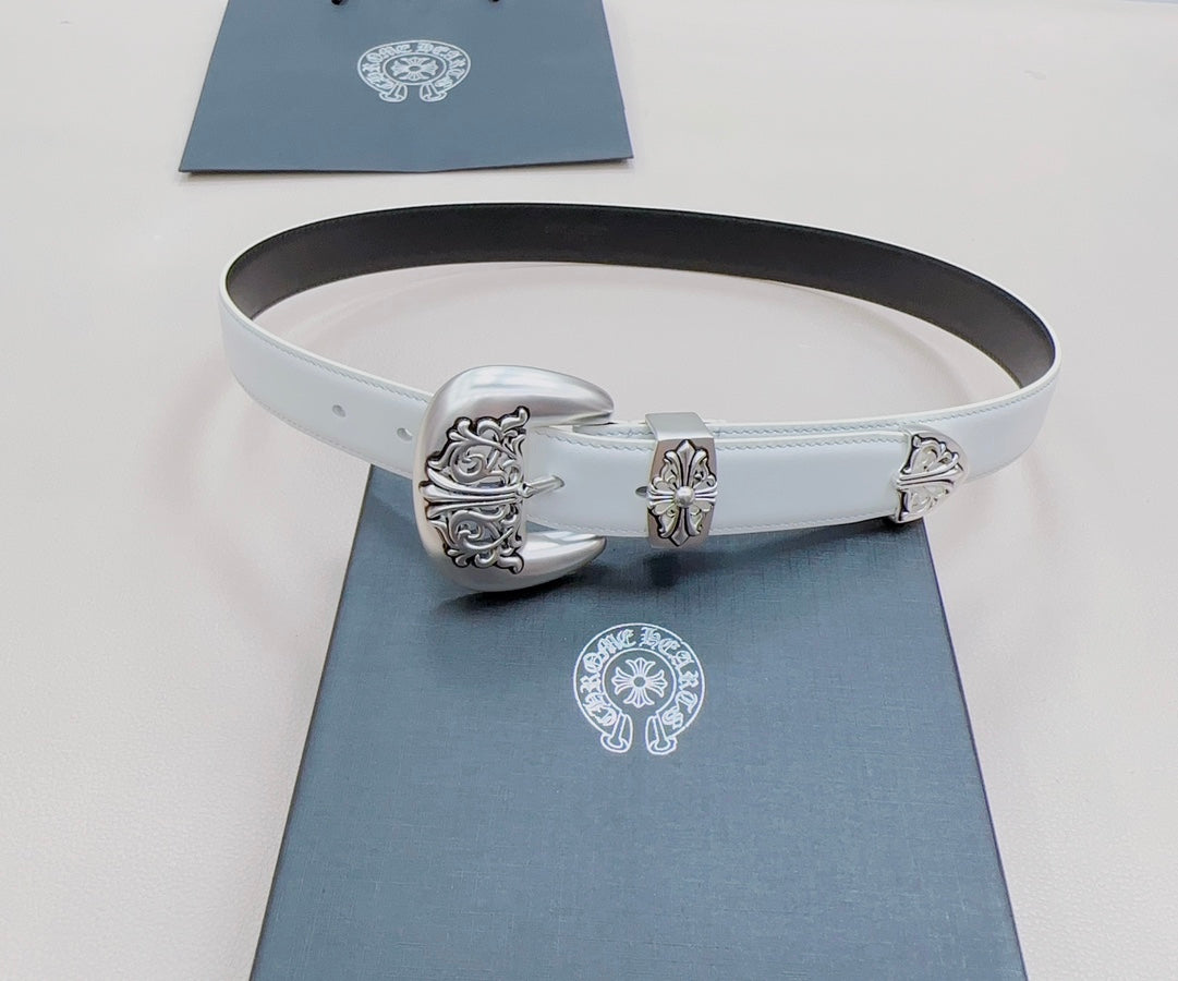 White leather belt with ornate silver buckle centerpiece and dark back strap