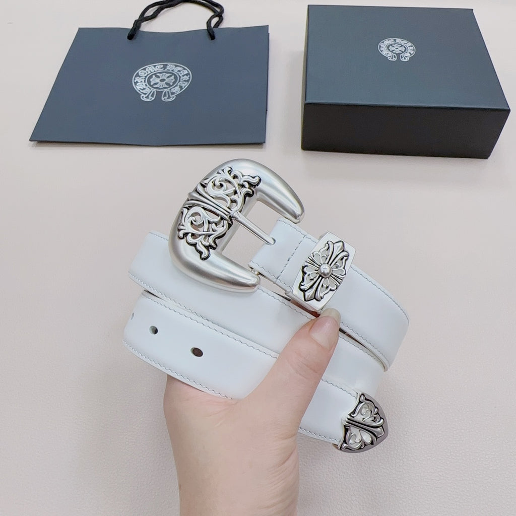 White leather belt with silver-toned buckle and floral accents, shown on hand