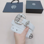 White leather belt with silver-toned buckle and floral accents, shown on hand