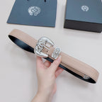 Chrome belt close-up with beige strap and silver ornate buckle