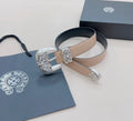 Chrome belt with beige leather strap and silver ornate buckle