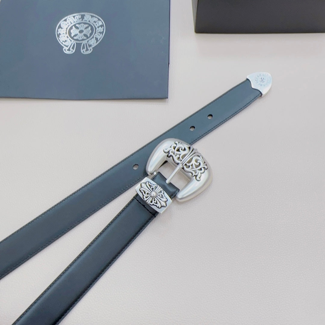 Chrome belt detail of silver buckle and dark blue strap with adjustment holes