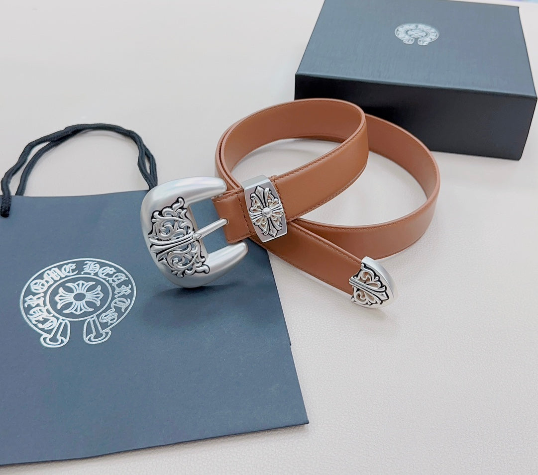 Brown leather belt with ornate silver buckle and engraved decorative accents