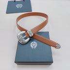 Brown leather belt with ornate silver buckle and engraved metal strap tips