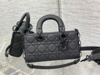 Quilted black Dior-style handbag with top handles and crossbody strap