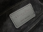 Black leather label reading “Christian Dior” and “MADE IN ITALY”
