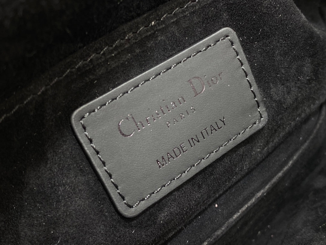 Black leather label reading “Christian Dior” and “MADE IN ITALY”