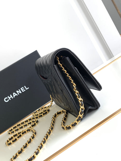 Black quilted leather flap shoulder bag with gold-tone chain strap, side view