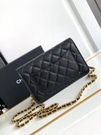 Quilted black leather flap shoulder bag with gold-tone chain strap, front view