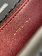 Burgundy leather bag interior with “MADE IN ITALY” stamp in gold lettering