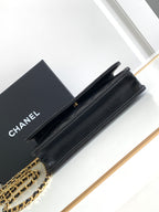 Black leather flap shoulder bag with gold-tone chain strap and top snap closure