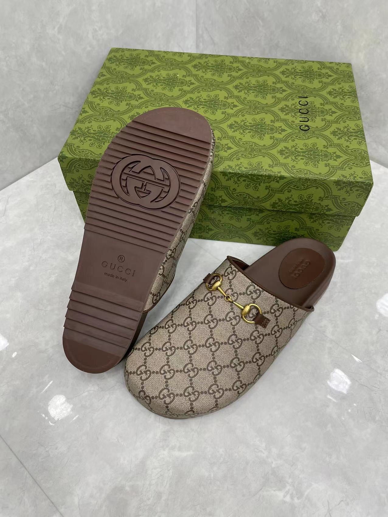 Gucci GG slide sandals, beige canvas with gold buckle and visible tread dark brown outsole