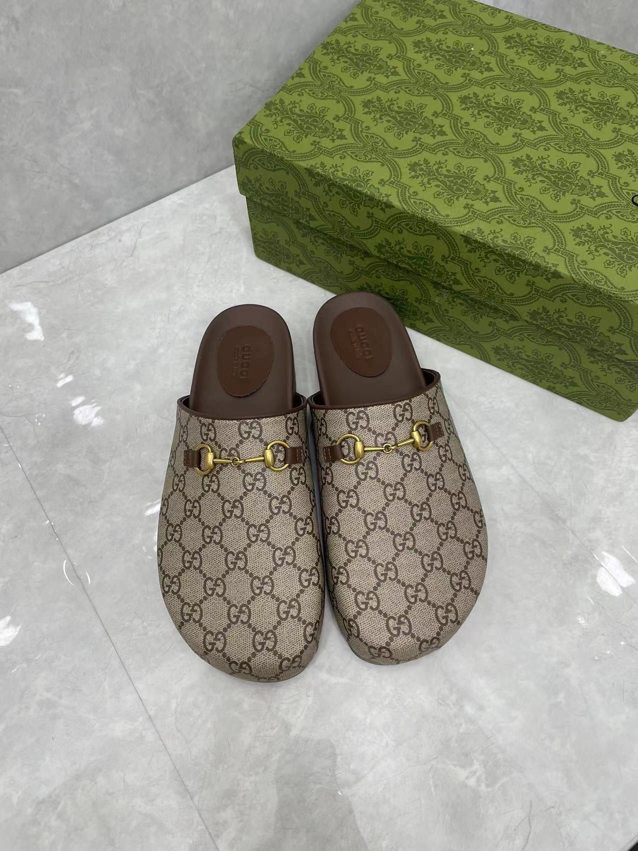 Gucci GG slide sandals, beige canvas with gold buckle hardware and dark brown inner sole