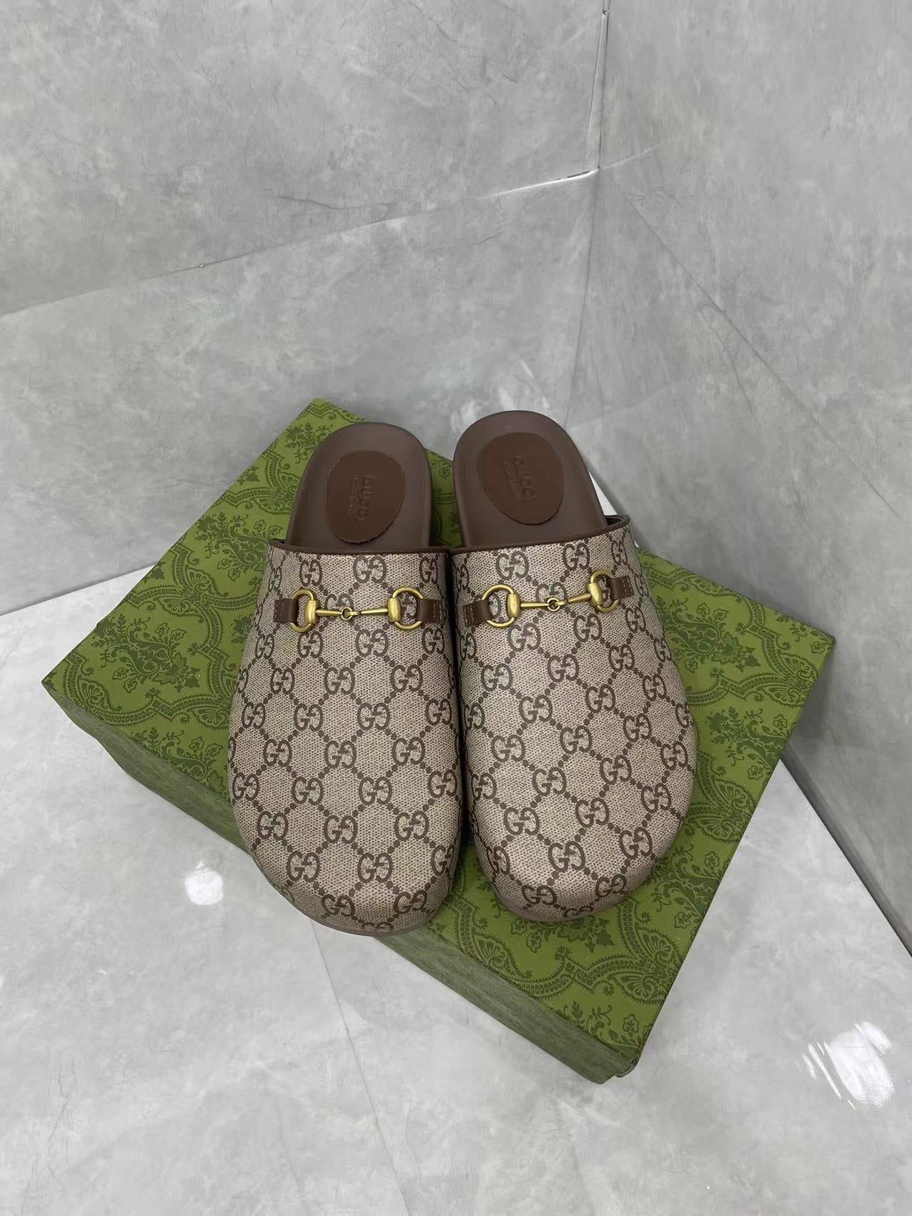 Gucci GG slide sandals, beige canvas with gold buckle hardware and dark brown footbed