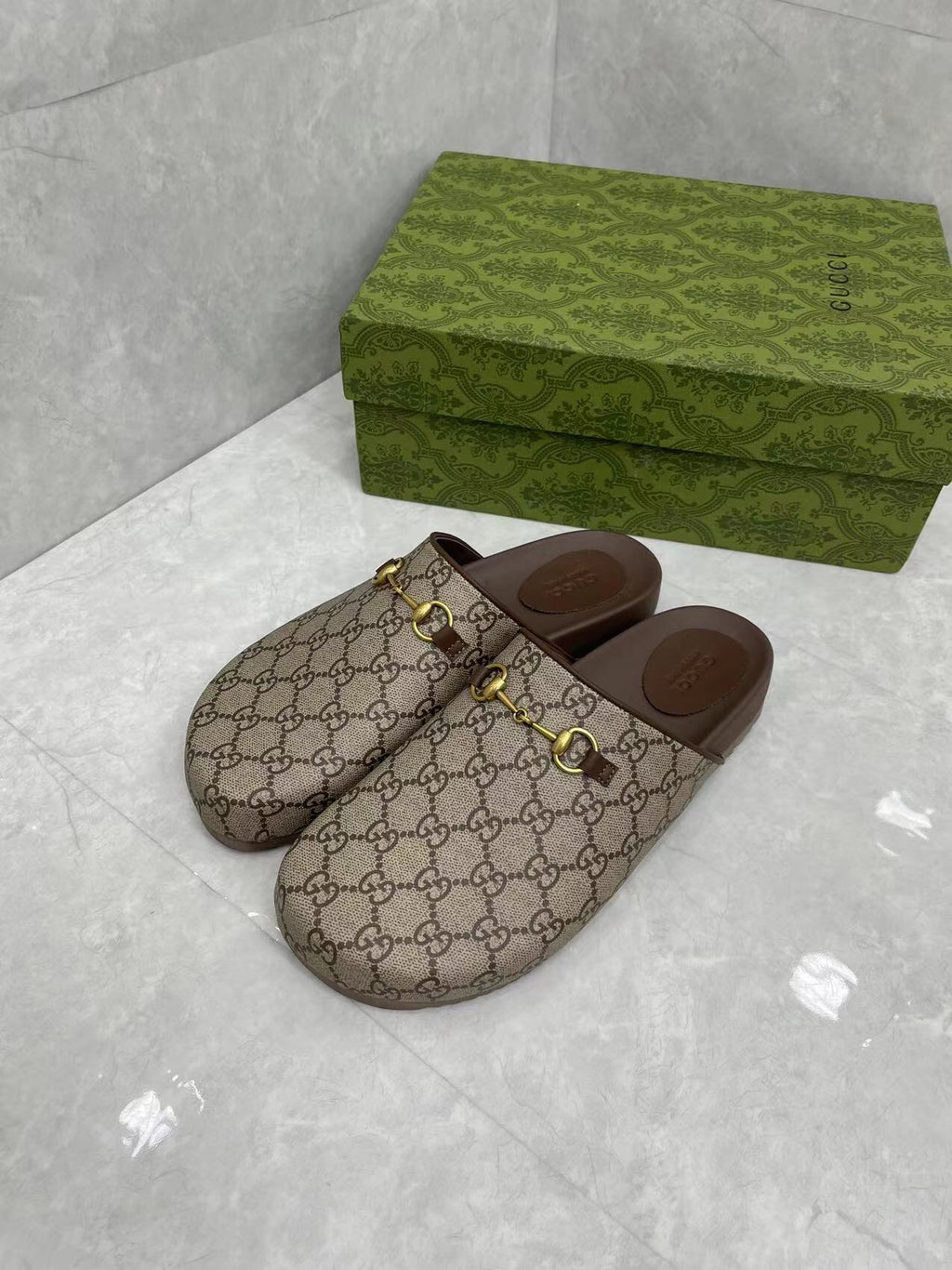 Gucci GG slide sandals, beige canvas uppers with gold buckle detail and dark brown soles