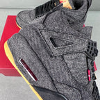 Denim high-top sneakers close-up with lace panel, burgundy pull tab, black outsole edge.