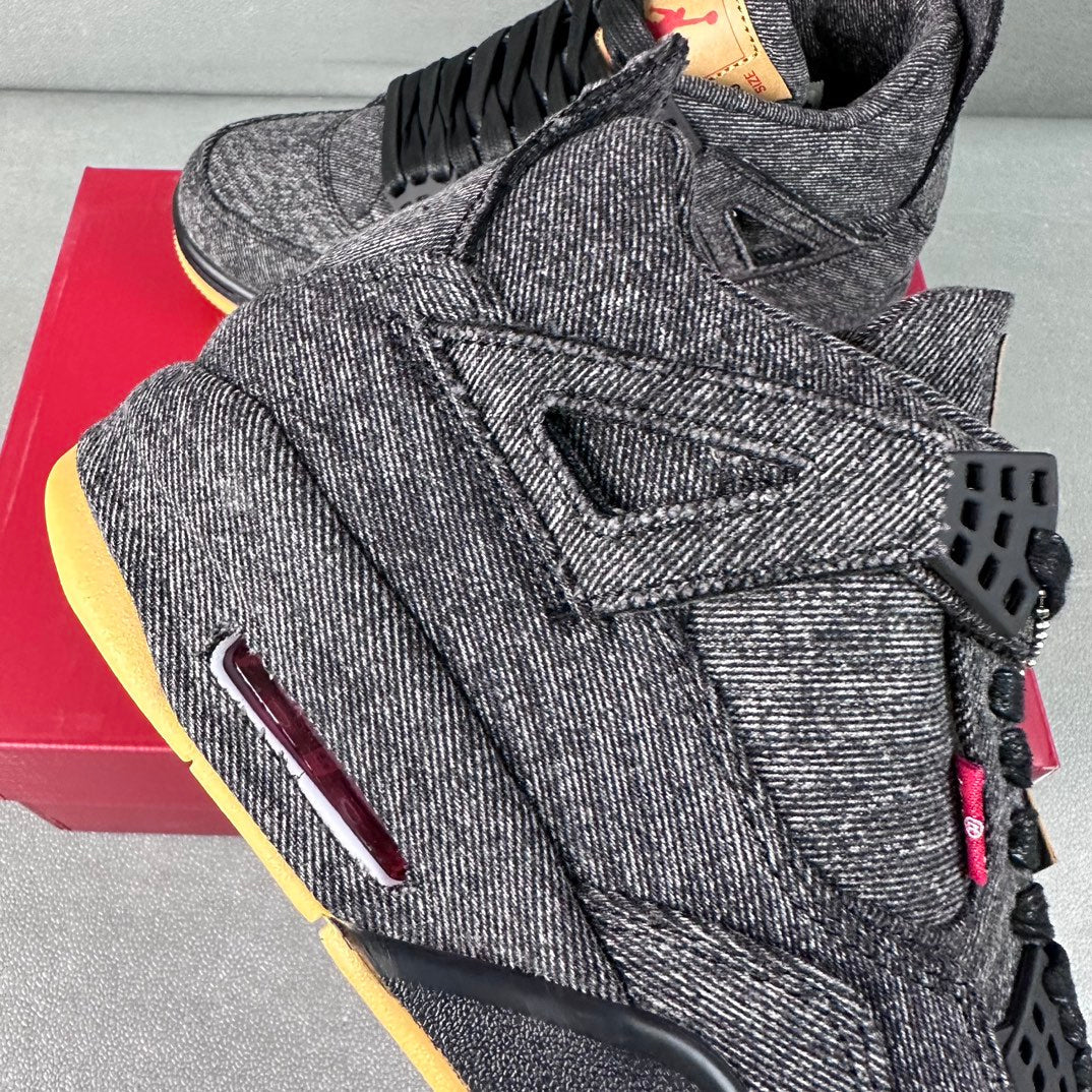 Denim high-top sneakers close-up with lace panel, burgundy pull tab, black outsole edge.