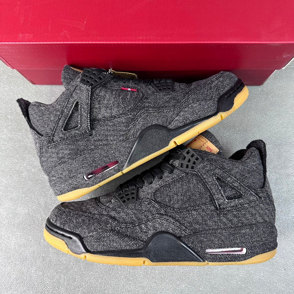 Denim high-top sneakers on red box, black laces, yellow outsole, red side accents.