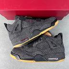 Denim high-top sneakers on red box, black laces, yellow outsole, red side accents.