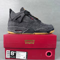 Denim high-top sneakers, black laces, yellow outsole, red lace accents, Jordan-style midsole.