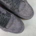Denim sneakers close-up: black lace eyelets, textured toe, dark rubber sole.