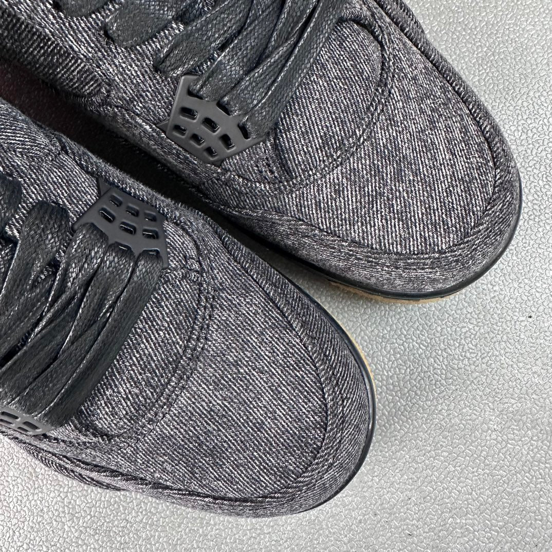 Denim sneakers close-up: black lace eyelets, textured toe, dark rubber sole.