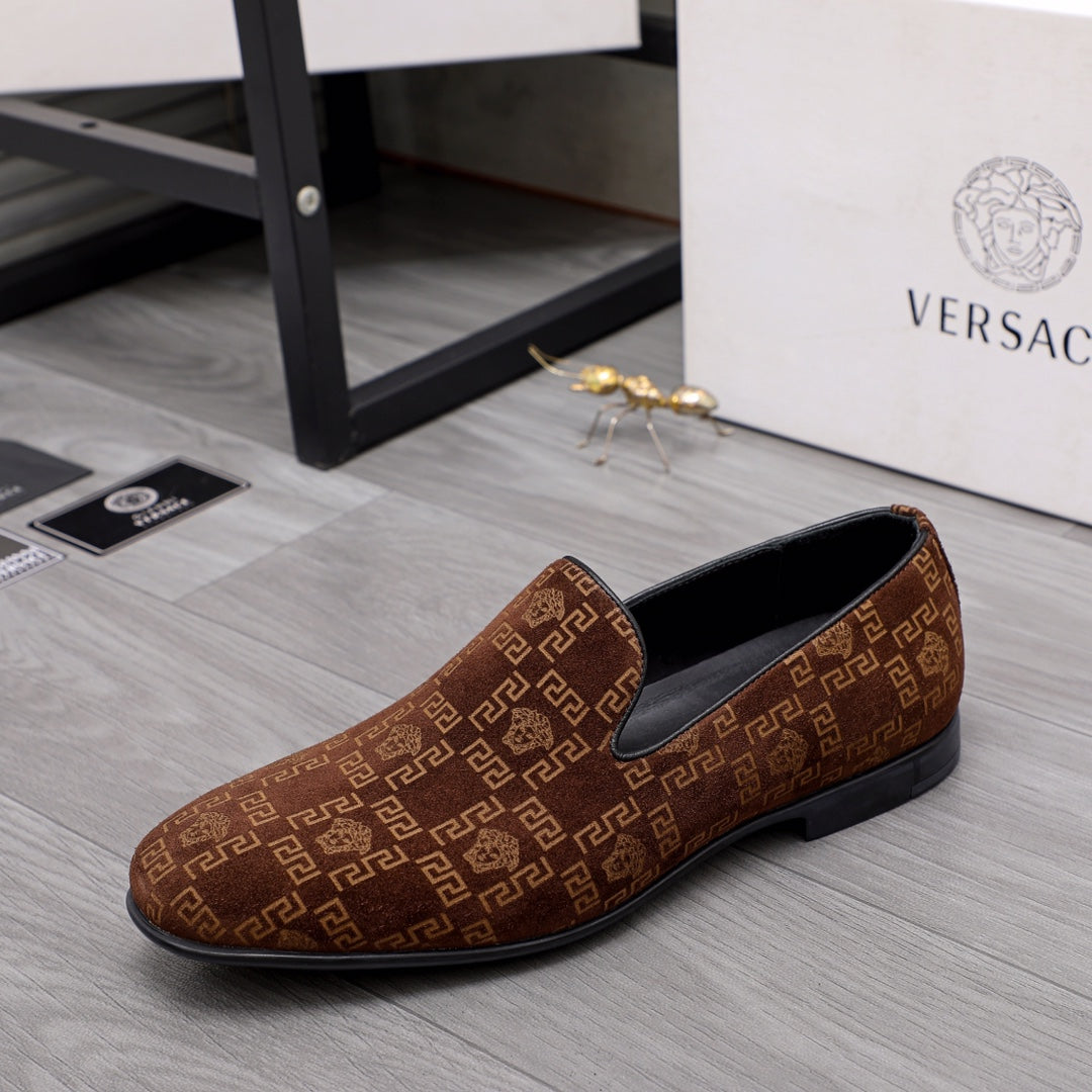 Versace luxury slip-on shoe in brown with repeating logo pattern and black rubber sole.