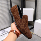 Versace luxury slip-on shoe in brown with repeating logo pattern and black sole.