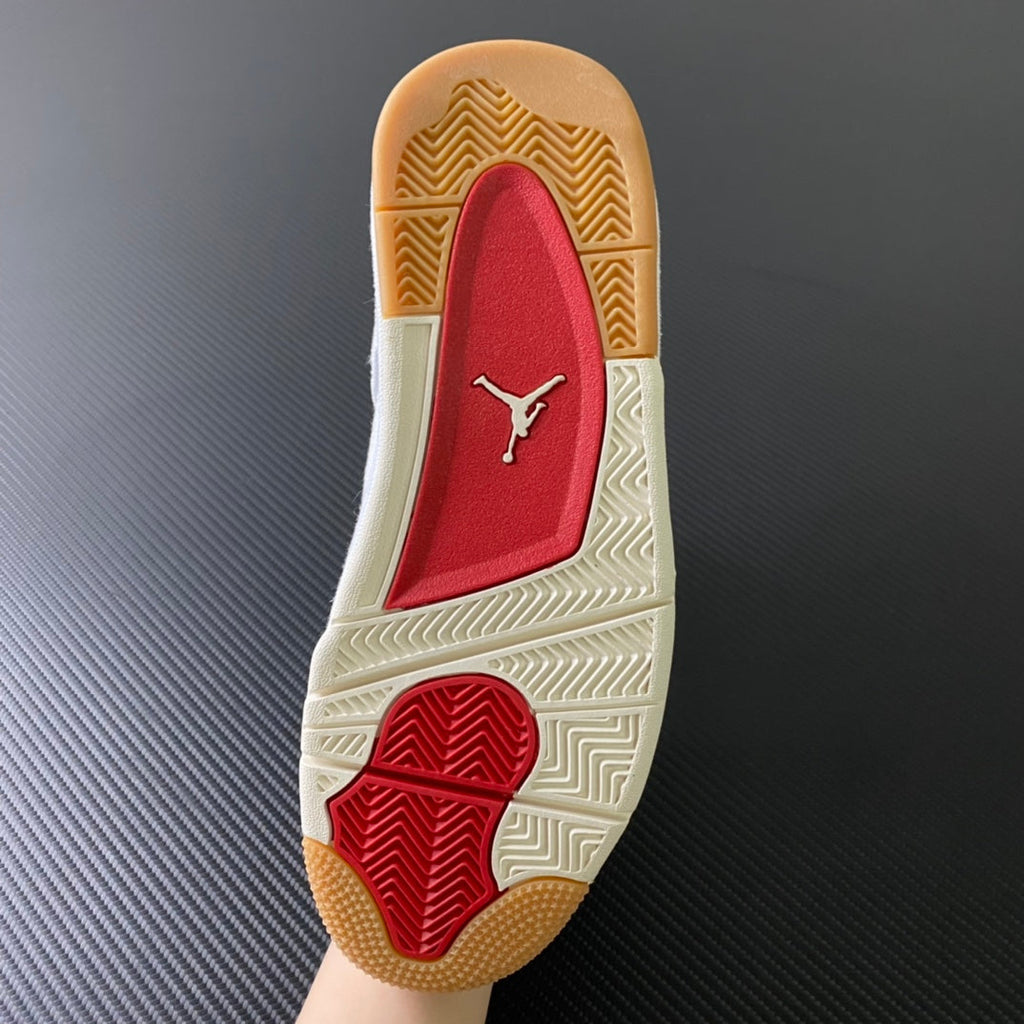 Shoe outsole with red Jumpman logo and zigzag tread on gum rubber base