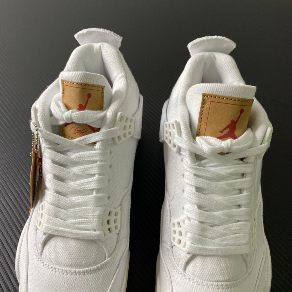 White high-top sneakers with tan heel labels and red Jumpman accents