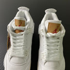 White high-top sneakers with tan heel labels and red Jumpman accents