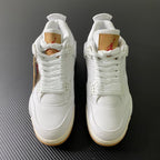 Pair of white high-top sneakers with lace-up closure and gum rubber soles