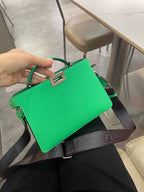 Green Fendi mini handbag front view with top handle and logo crossbody strap