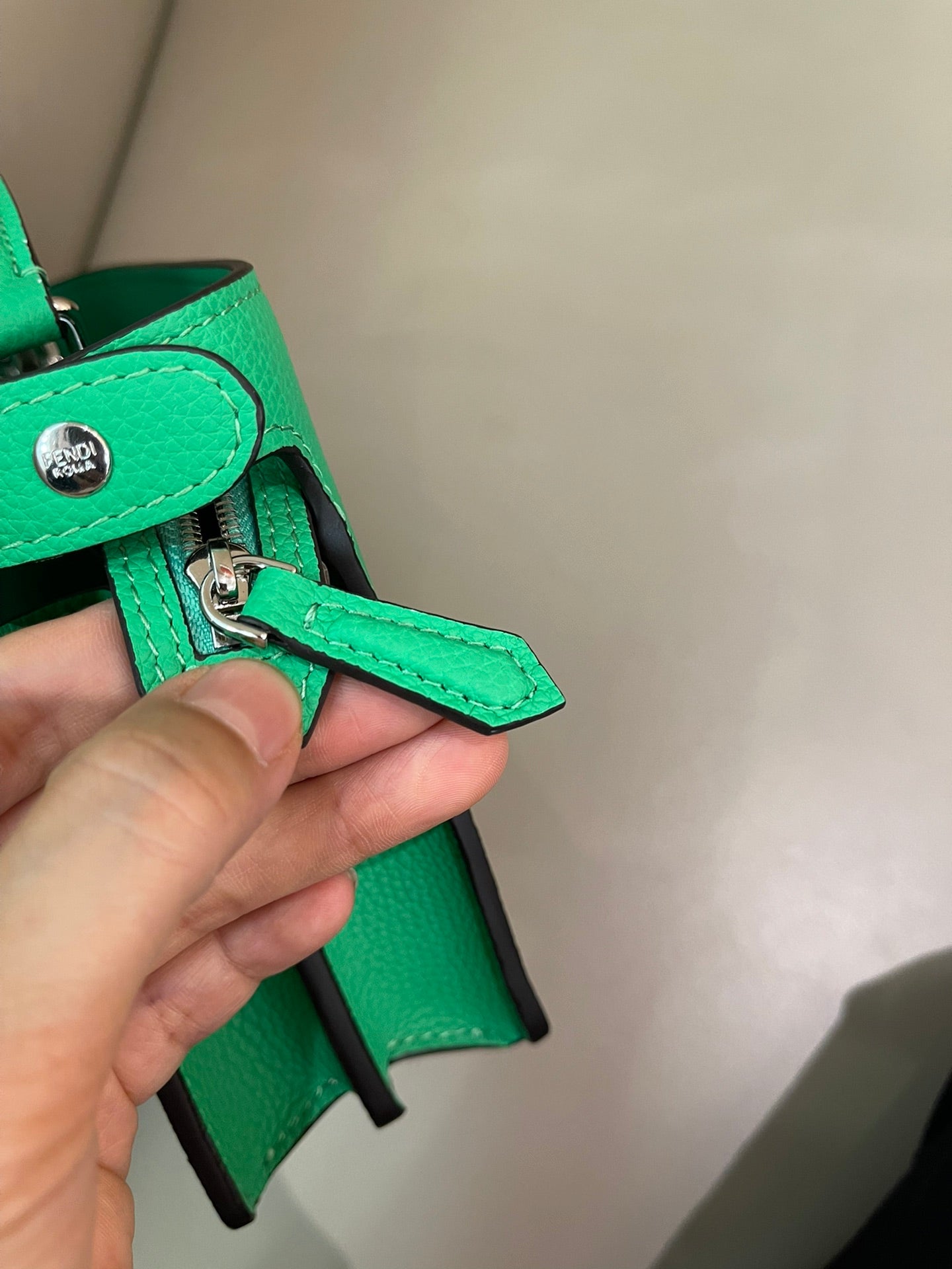 Green mini handbag strap end with engraved metal snap hardware