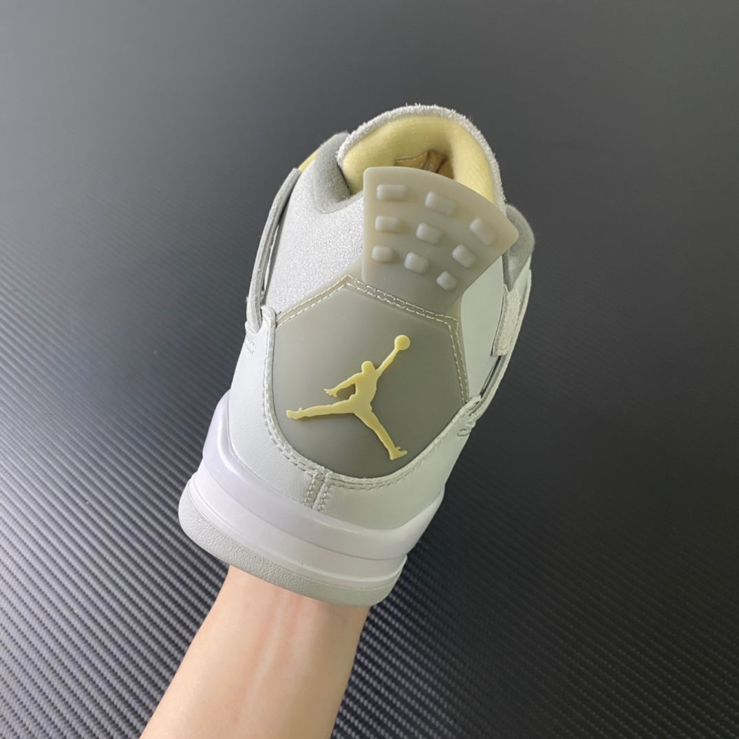 Heel of mid-top sneaker with off-white leather, suede collar, and gold Jumpman logo