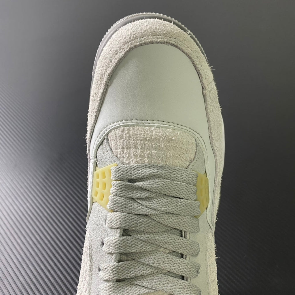 Front upper of mid-top sneaker with lace-up front and off-white suede tongue lining
