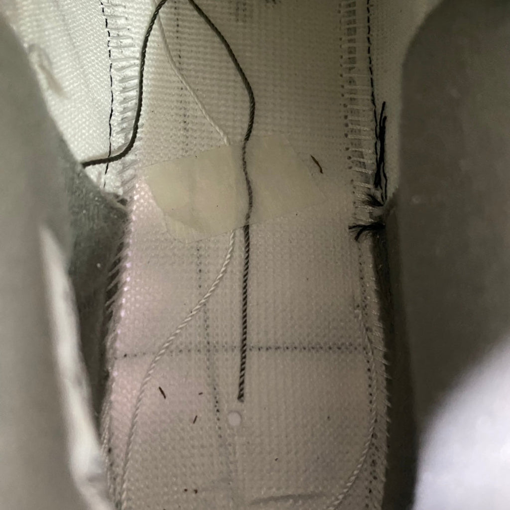 Sneaker interior lining close-up with stitched seams and smooth fabric texture
