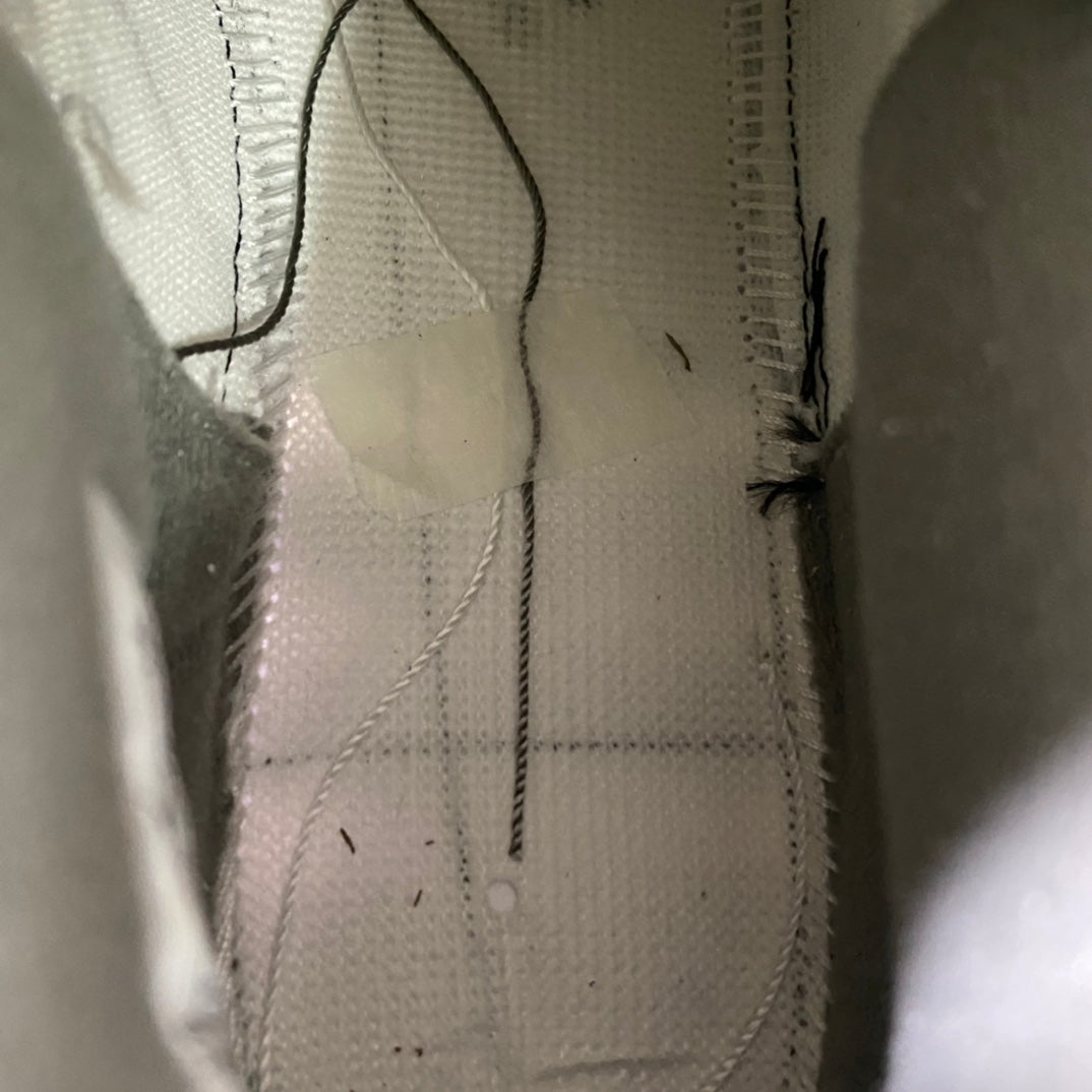 Sneaker interior lining close-up with stitched seams and smooth fabric texture