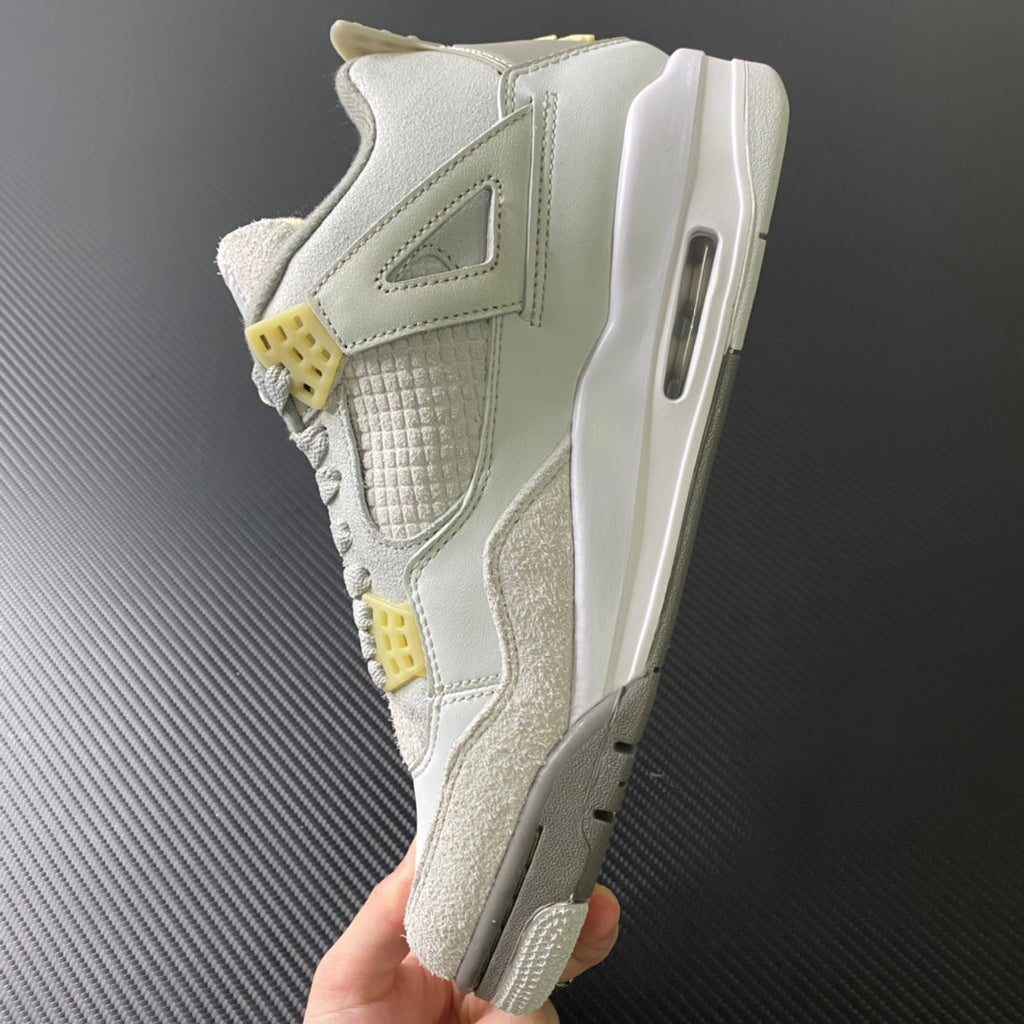 Mid-top sneaker profile with visible air window, off-white leather, beige suede, yellow tabs