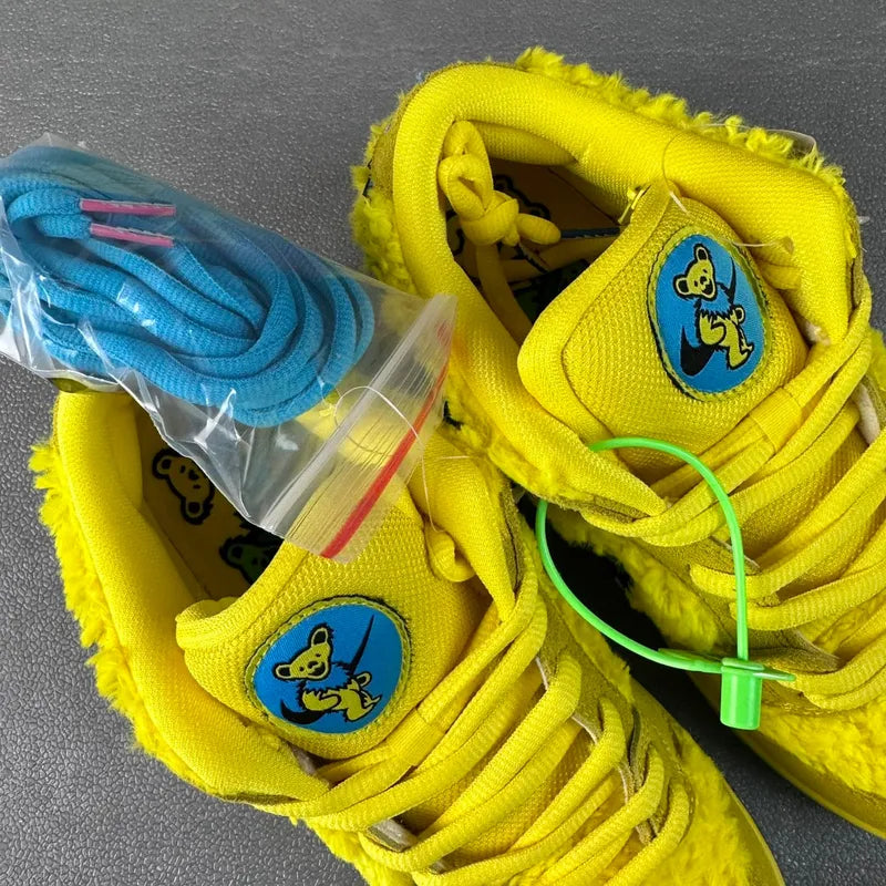 Yellow sneakers with fuzzy laces and tongue patches featuring a cartoon bear