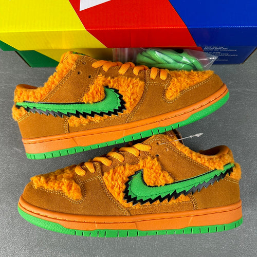 Orange-brown low-top sneakers, green swoosh overlays and fuzzy interior, side view
