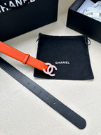 Orange Chanel belt with silver-tone CC buckle and adjustable punched strap